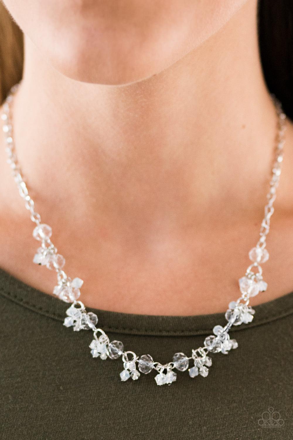 Paparazzi Accessories Leading STARLIGHT - White Glassy and faceted white crystal beading trickles along a silver chain, creating a dramatic fringe below the collar. Featuring elegant pear-shaped cuts, iridescent crystals cluster atop the glassy gems for a