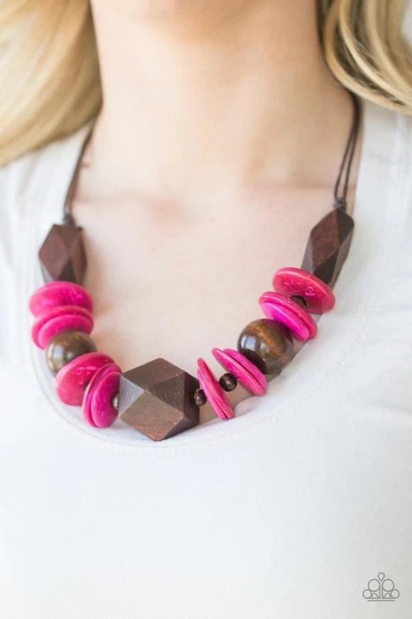 Paparazzi Accessories Pacific Paradise - Pink Featuring abstract geometric finishes, mismatched brown wooden beads and vivacious pink accents are threaded along shiny brown cording. A dramatic geometric bead adorns the center, creating a bold summery look