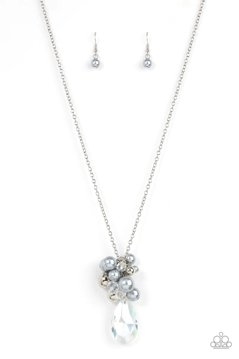 Paparazzi Accessories Drip Drop Dazzle - Silver Featuring an iridescent shimmer, a dramatically oversized crystal-like teardrop swings from the bottom of a cluster of shiny silver, pearly silver, and crystal-like beads, creating a dazzling pendant at the