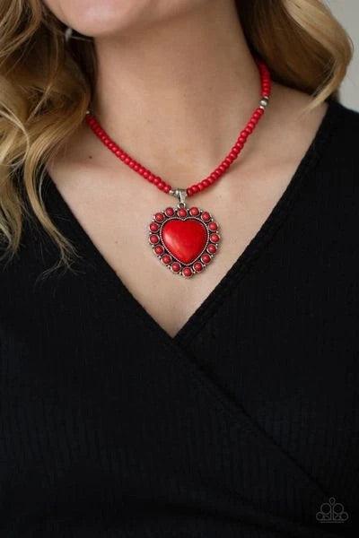 Paparazzi Accessories A Heart of Stone - Red Bordered by dainty red stones, an oversized red stone heart pendant swings from the bottom of a red stone and silver beaded display below the collar for a flirtatiously earthy fashion. Features an adjustable cl