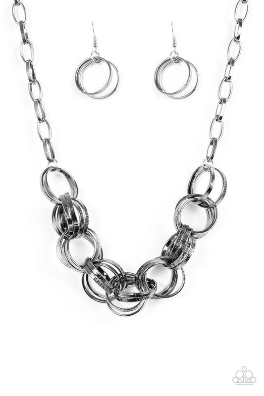 Paparazzi Accessories Statement Made - Black Etched in light-catching shimmer, glistening gunmetal rings link below the collar, connecting into a bold clustered fringe for a fierce industrial look. Features an adjustable clasp closure. Jewelry