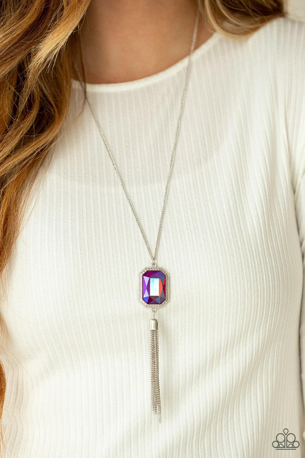 Paparazzi Accessories Blissed Out Opulence - Pink An impressive pink emerald cut gem is pressed into the center of a silver studded frame, creating an ethereal pop of color at the bottom of a lengthened silver chain. A silver chain tassel swings from the