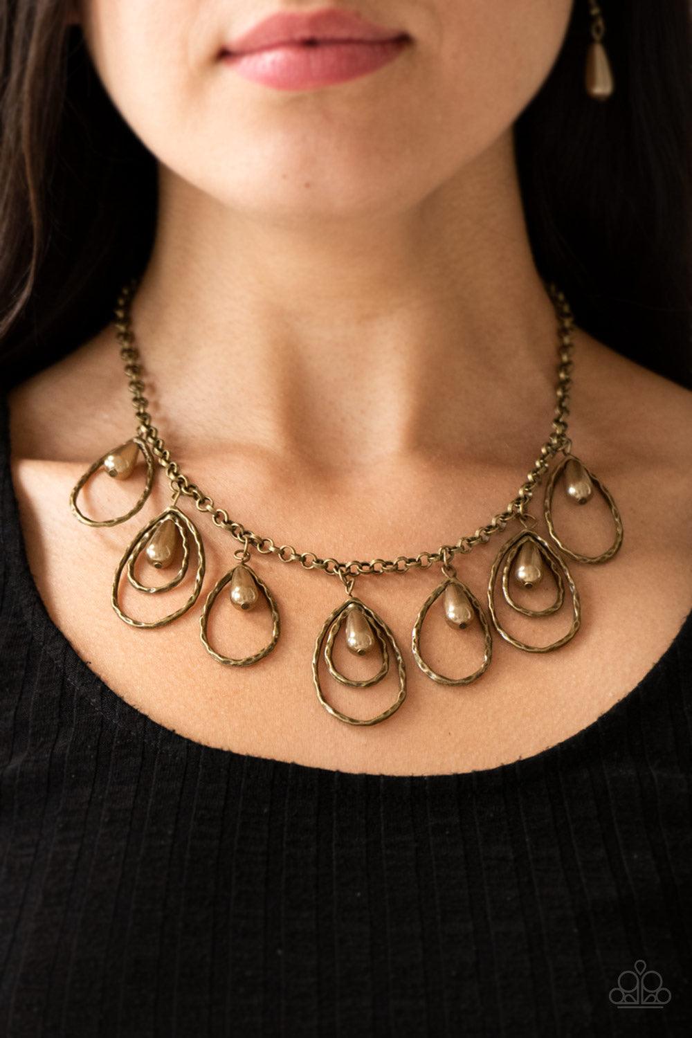Paparazzi Accessories Rustic Ritz - Brass Pearly brass teardrop beads swing from the tops of delicately hammered brass teardrop frames, creating a refined fringe below the collar. Features an adjustable clasp closure. Jewelry