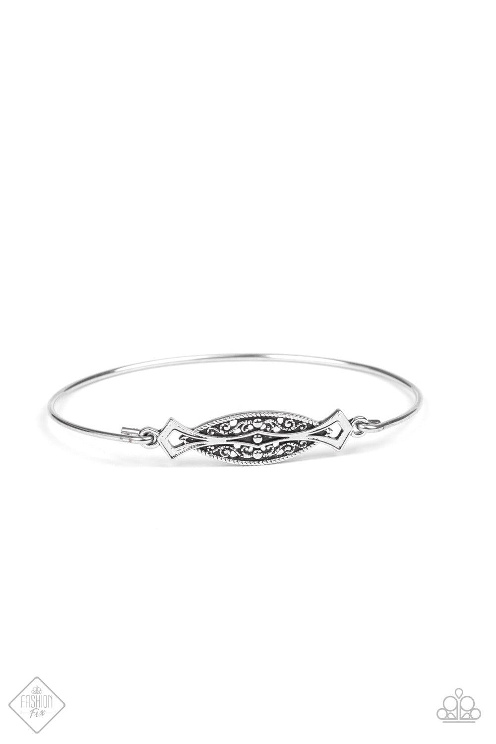 Paparazzi Accessories Exquisitely Empress - Silver An almond shaped frame is filled with vintage textures and nestled between two sleek silver bars for a minimalistic look. Jewelry