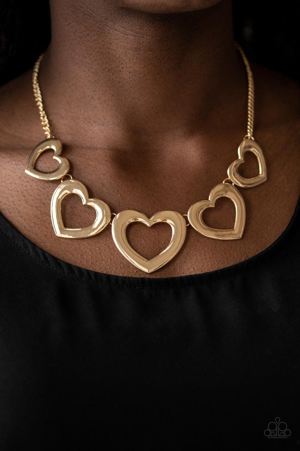 Paparazzi Accessories Hearty Hearts - Gold Gradually increasing in size, glistening gold heart silhouettes delicately link below the collar in a charming fashion. Features an adjustable clasp closure. Jewelry