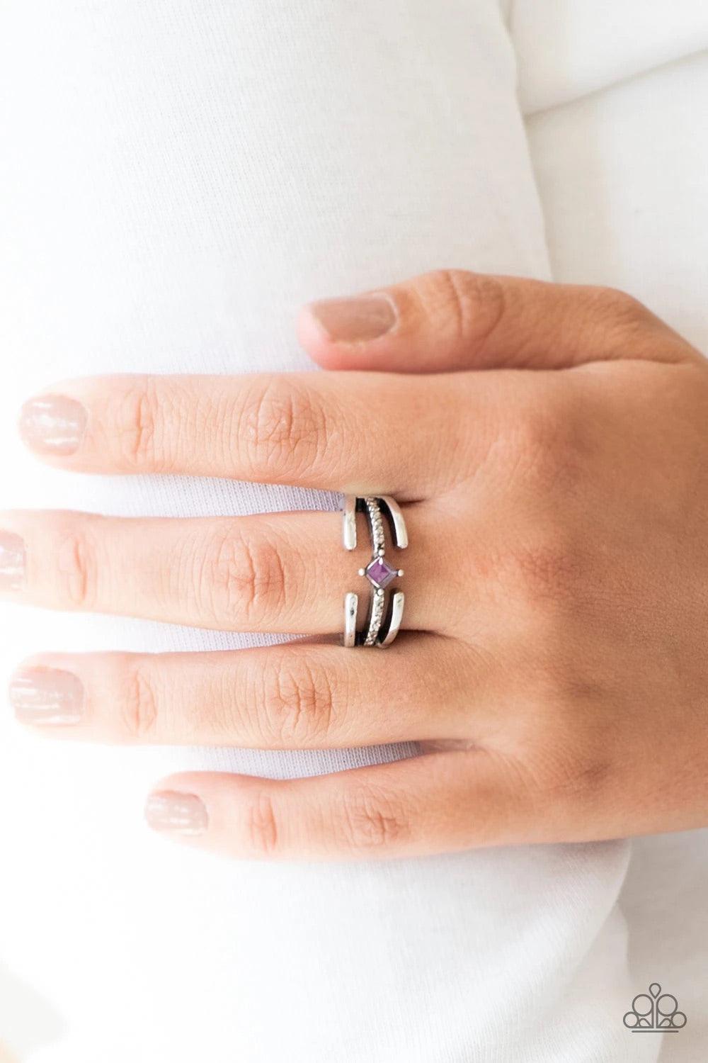 Paparazzi Accessories City Center - Purple Glistening silver bars gather around a sparkling hematite rhinestone encrusted band. Featuring a regal square cut, a purple rhinestone is pressed into the center for an edgy finish. Features a dainty stretchy ban