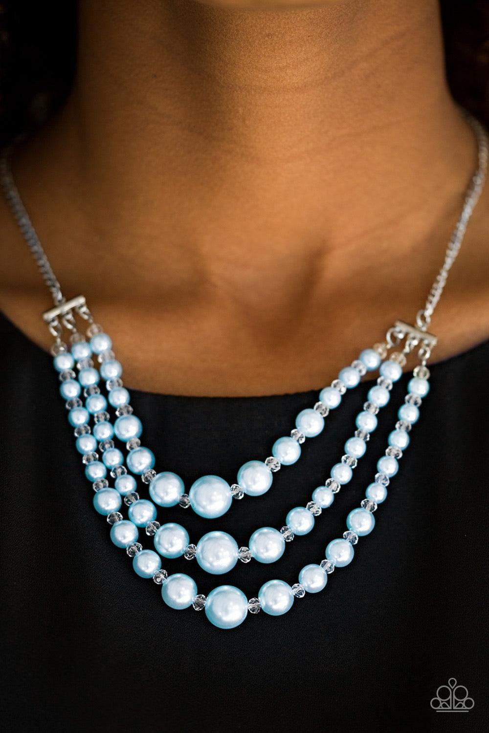 Paparazzi Accessories Spring Social - Blue Varying in size, three strands of timeless blue pearls swing from the bottom of a shimmery silver chain. Dainty crystal-like beads are sprinkled between the pearl accents, adding classic shimmer to the elegant pa