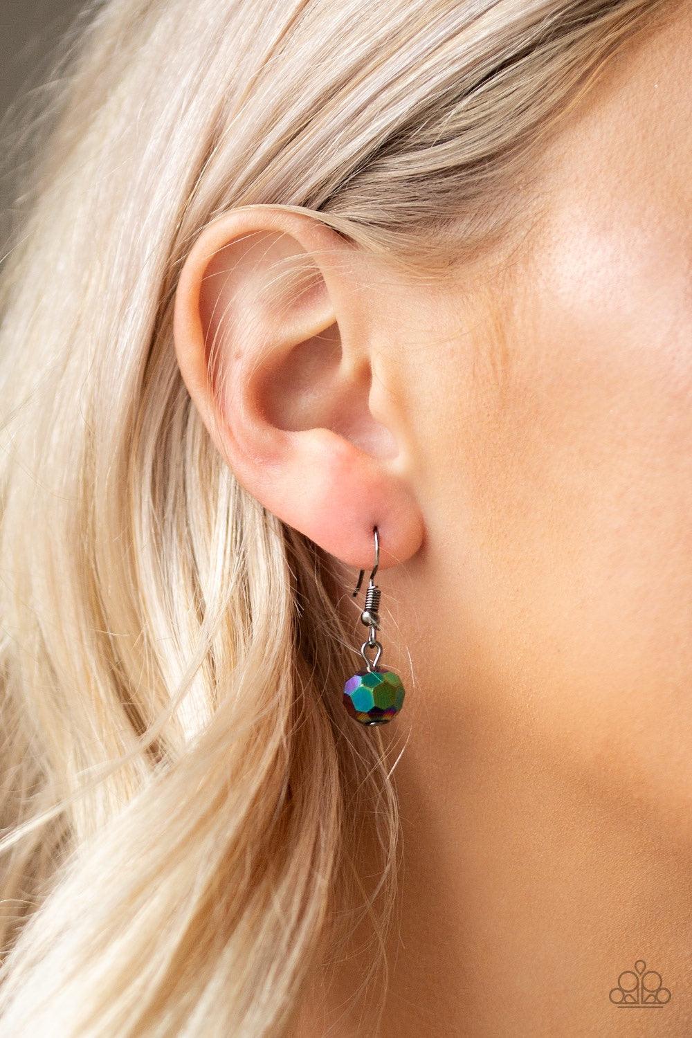 Paparazzi Accessories Metro Majestic - Multi A collection of airy gunmetal beads, faceted rainbow metallic beads, and hematite rhinestone encrusted rings are threaded along an invisible wire below the collar for a statement-making fashion. Features an adj