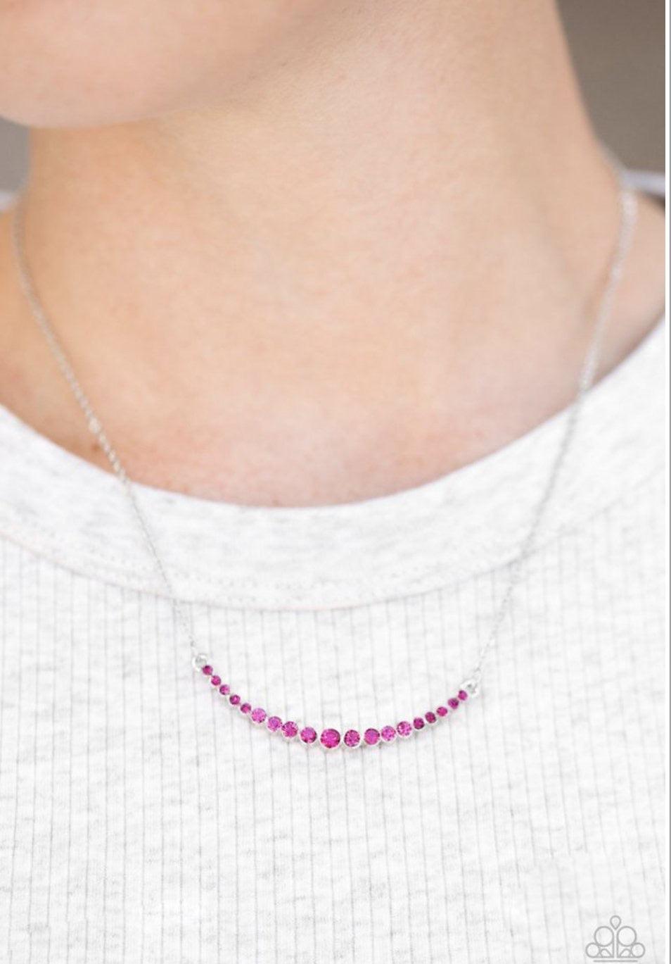 Paparazzi Accessories Rockin Rhinestones - Pink Glittery pink rhinestones join into a bowing pendant, creating a timeless frame below the collar. The sparkling rhinestones gradually increase in size as they near the center of the pendant for a classic fin