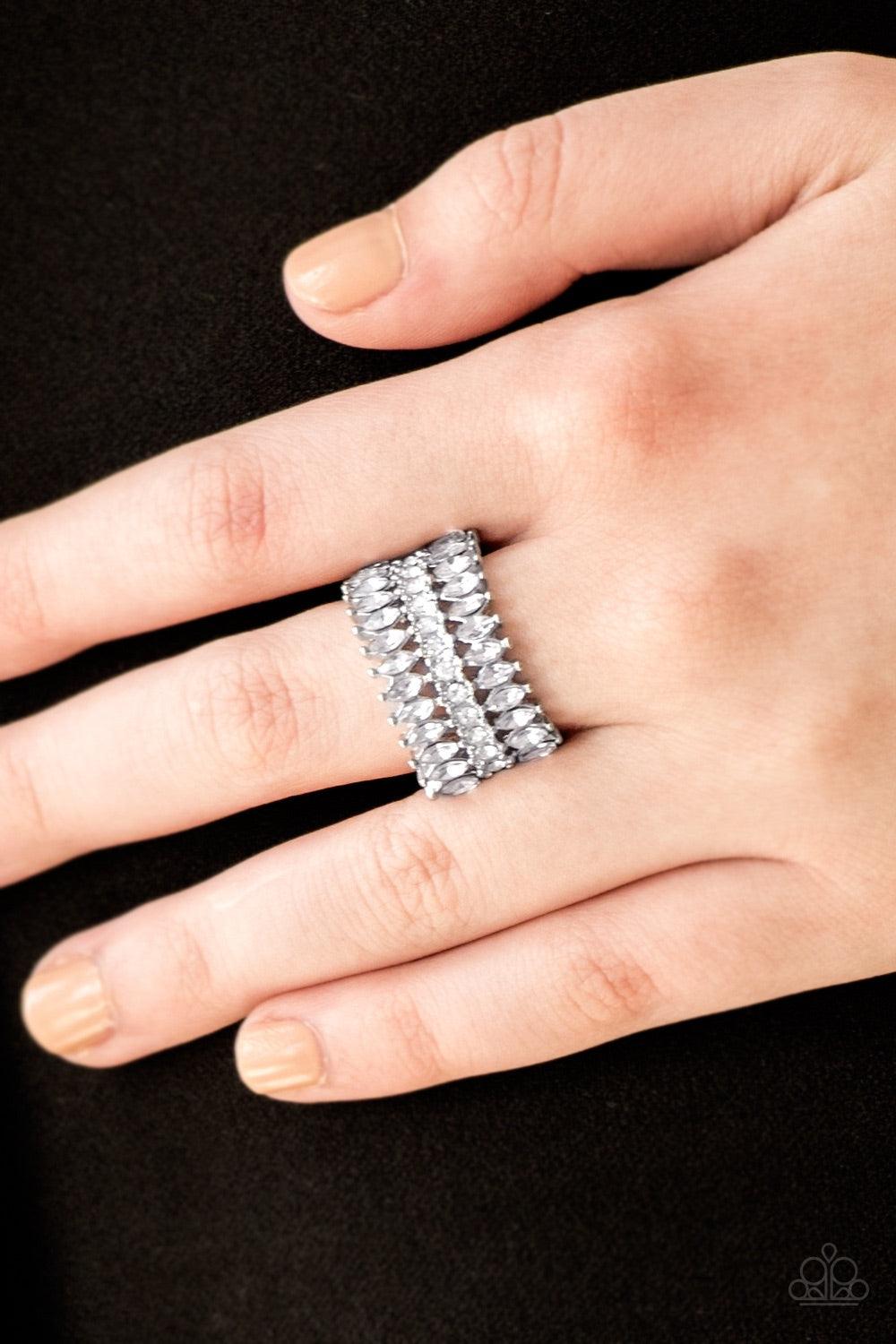 Paparazzi Accessories Treasury Fund - White Featuring refined marquise cuts, glittery white rhinestones flare from a center of glassy white rhinestones, creating a regal band across the finger. Features a stretchy band for a flexible fit. Jewelry