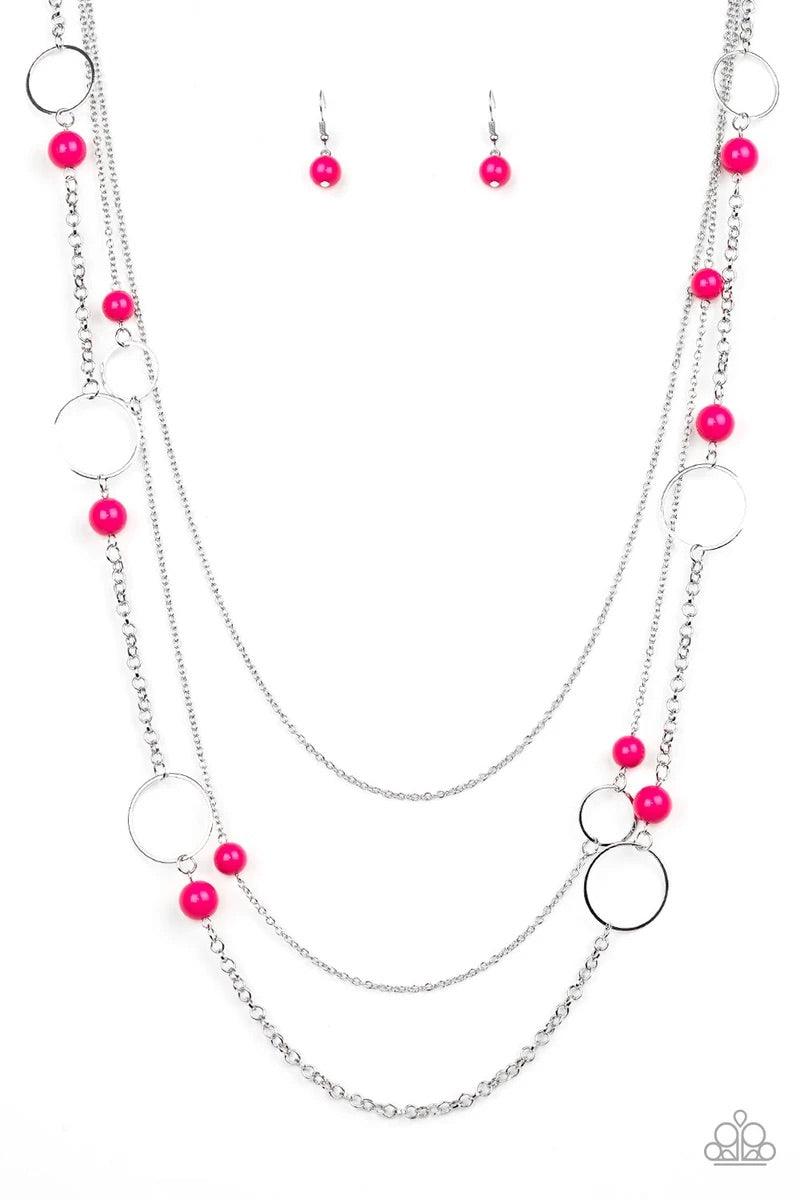 Paparazzi Accessories Beachside Babe - Pink Featuring vivacious pink beads and shimmery silver hoops, mismatched silver chains layer down the chest for a seasonal look. Features an adjustable clasp closure. Sold as one individual necklace. Includes one pa