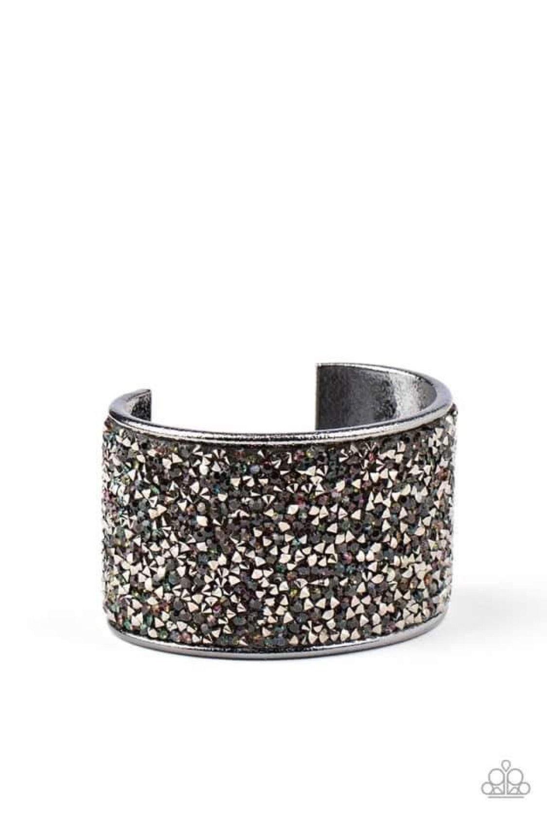 Paparazzi Accessories Stellar Radiance - Multi A brilliant collision of iridescent blue and hematite rhinestones are encrusted across the front of a thick gunmetal cuff, creating a stellar sparkle. Sold as one individual bracelet. Jewelry