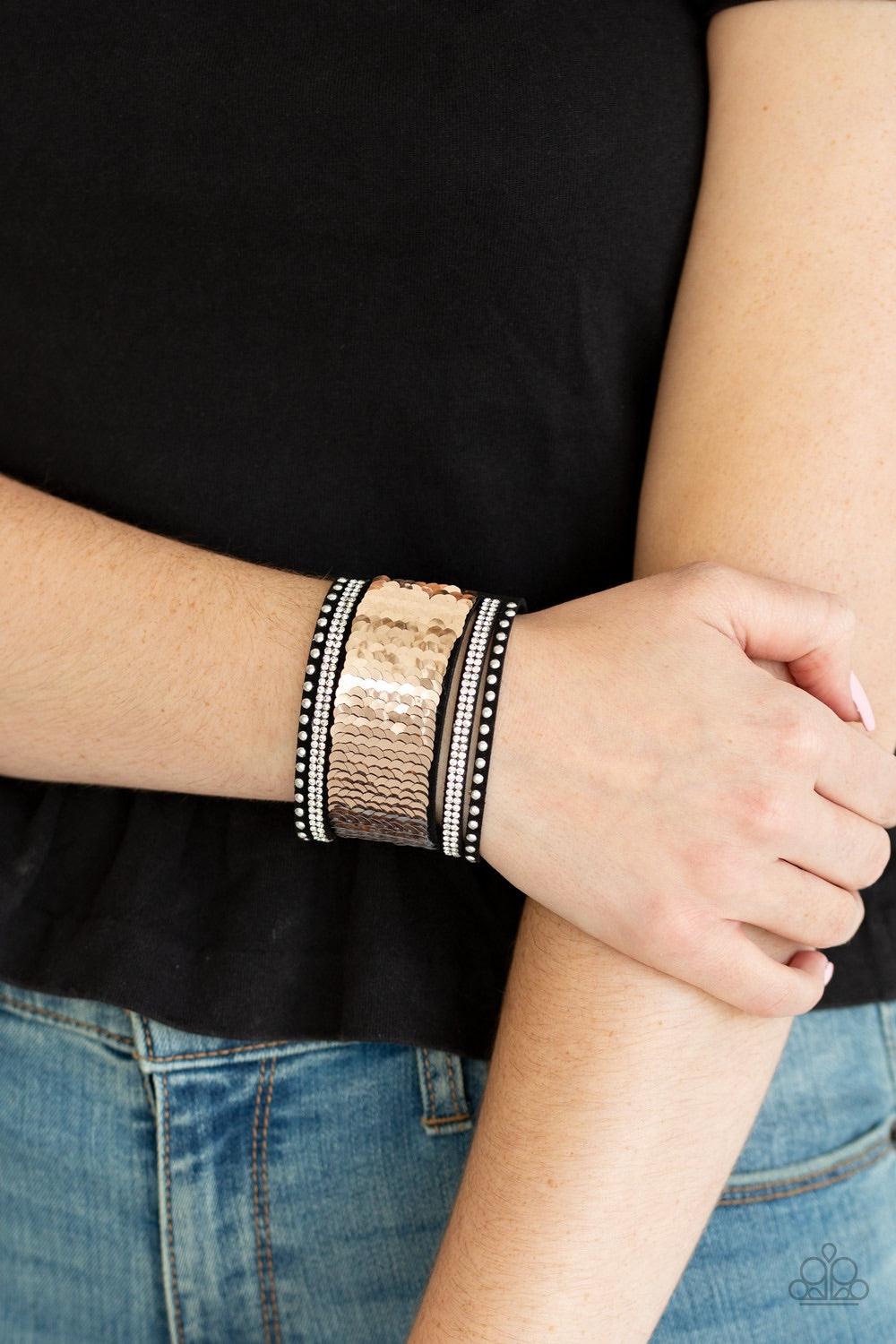 Paparazzi Accessories MERMAIDS Have More Fun - Gold Shiny silver studs, glassy white rhinestones, and shimmering sequins are sprinkled across a thick black suede band that has been spliced into five glittery rows. Bracelet features reversible sequins that