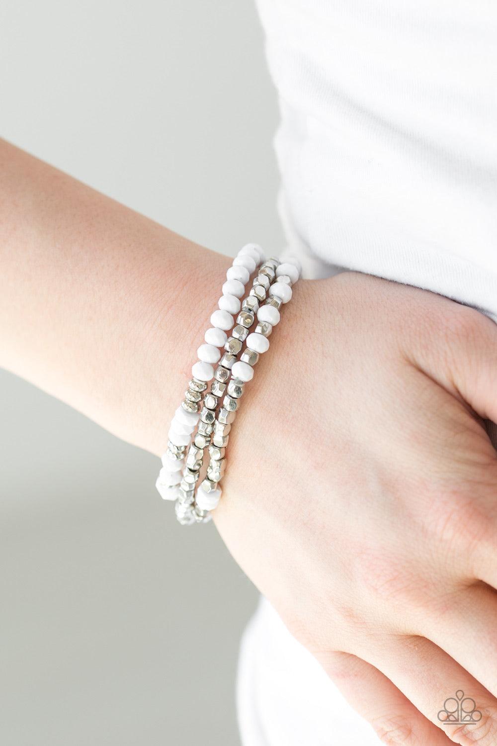 Paparazzi Accessories Very Vivacious ~White A mishmash of faceted white and silver beads are threaded along stretchy elastic bands, creating colorful layers across the wrist. Sold as one set of three bracelets.