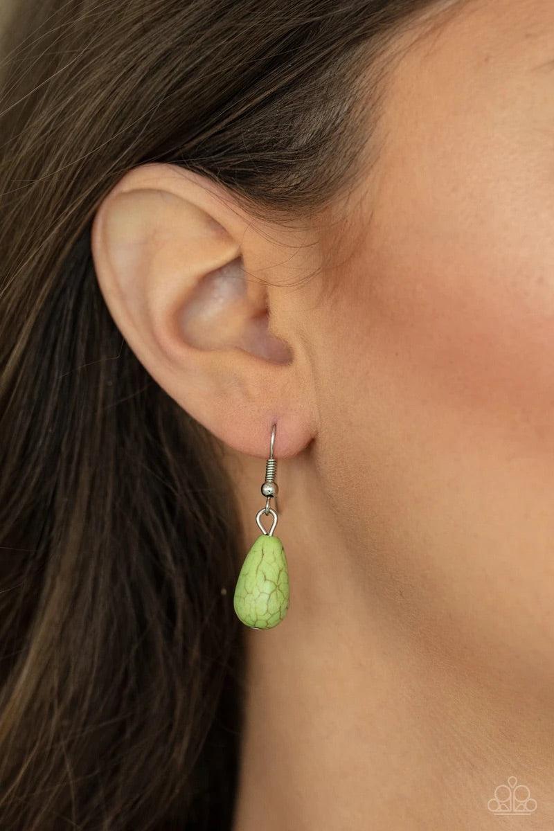 Paparazzi Accessories Cowgirl Couture - Green An Apple Green oval stone sits center stage surrounded by swirly designs stamped into a wide silver frame. A fringe of silver floral beads culminating in Apple Green stones swings like a pendulum at the end of