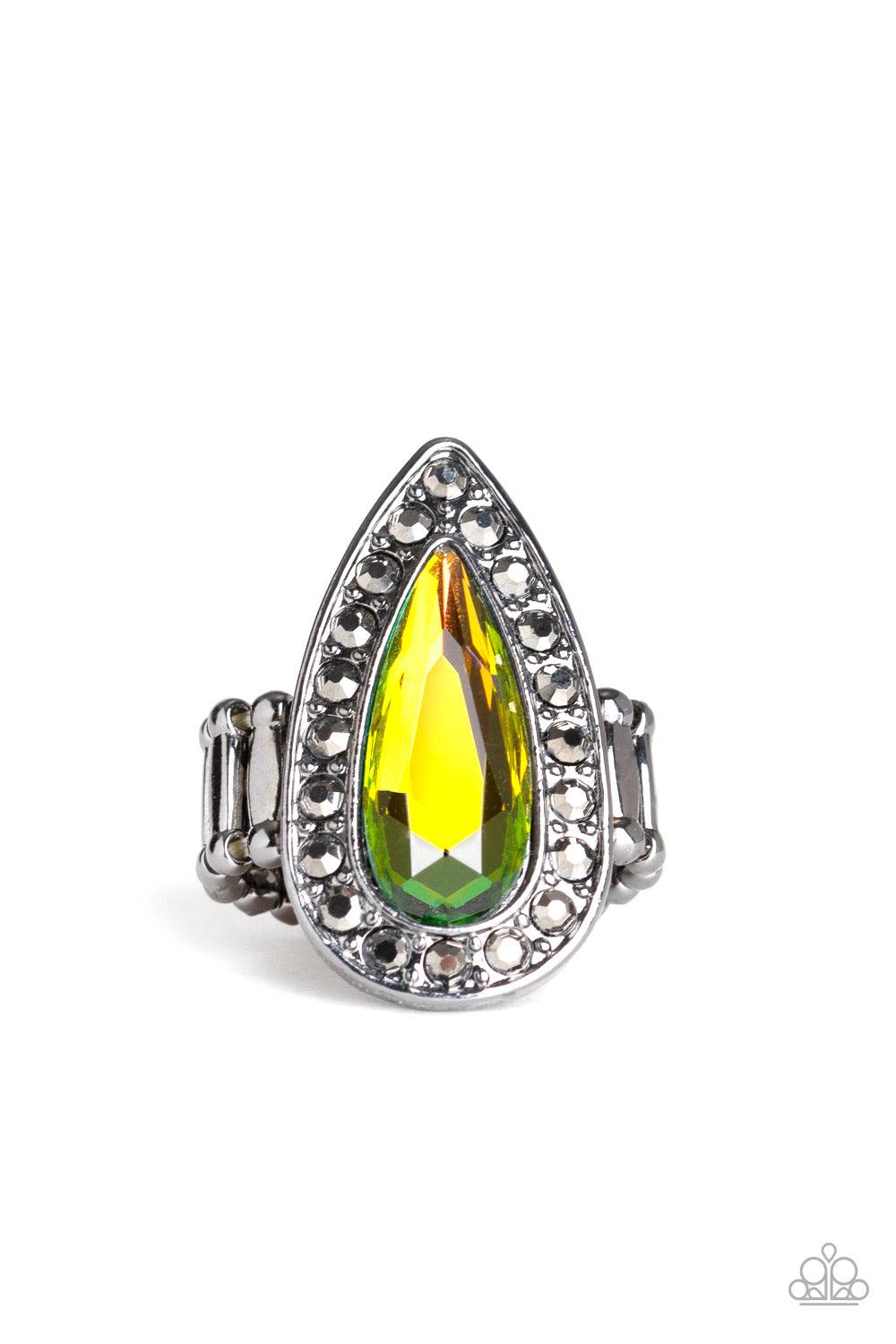 Paparazzi Accessories Majestic Mayhem - Multi An oversized rainbow teardrop gem is pressed in the center of a glistening gunmetal teardrop frame radiating with glittery hematite rhinestones for a fierce look. Features a stretchy band for a flexible fit. J