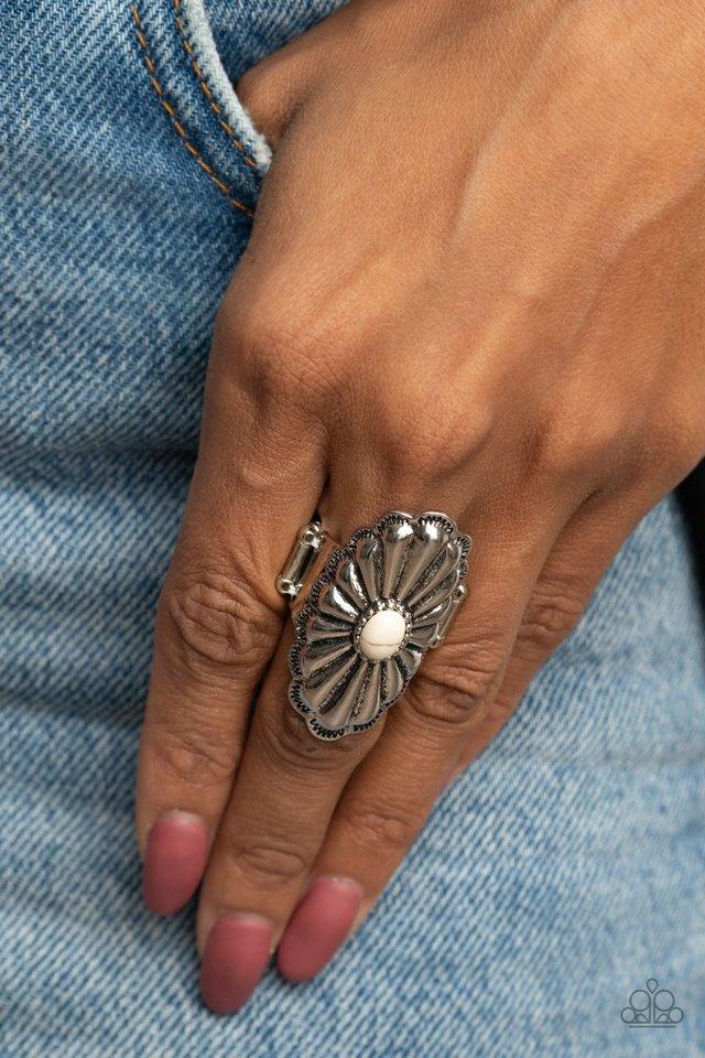 Paparazzi Accessories Cottage Couture - White Beveled silver petals fan out from the center of an oval white stone atop a scalloped silver frame, creating a whimsically rustic centerpiece atop the finger. Features a stretchy band for a flexible fit. Jewel
