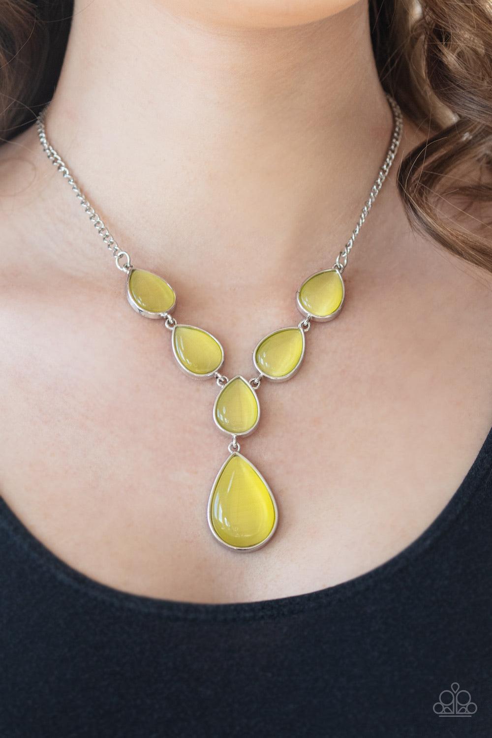 Paparazzi Accessories Dewy Decadence - Yellow A series of yellow cat's eye teardrops interlock at the bottom of a silver chain, giving way to an oversized teardrop pendant for a refined finish. Features an adjustable clasp closure. Jewelry
