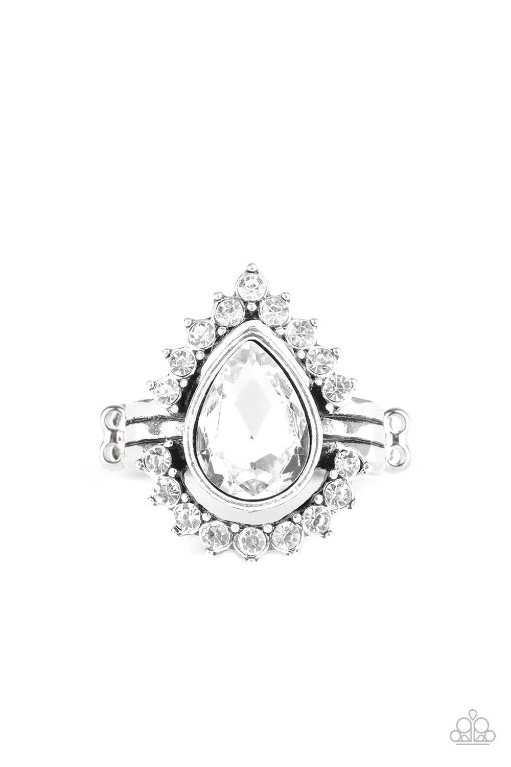 Paparazzi Accessories Make Your TRADEMARK - White A ring of glittery white rhinestones fans out from a dramatically oversized white teardrop rhinestone center, creating the illusion of a floating centerpiece. Features a stretchy band for a flexible fit.So