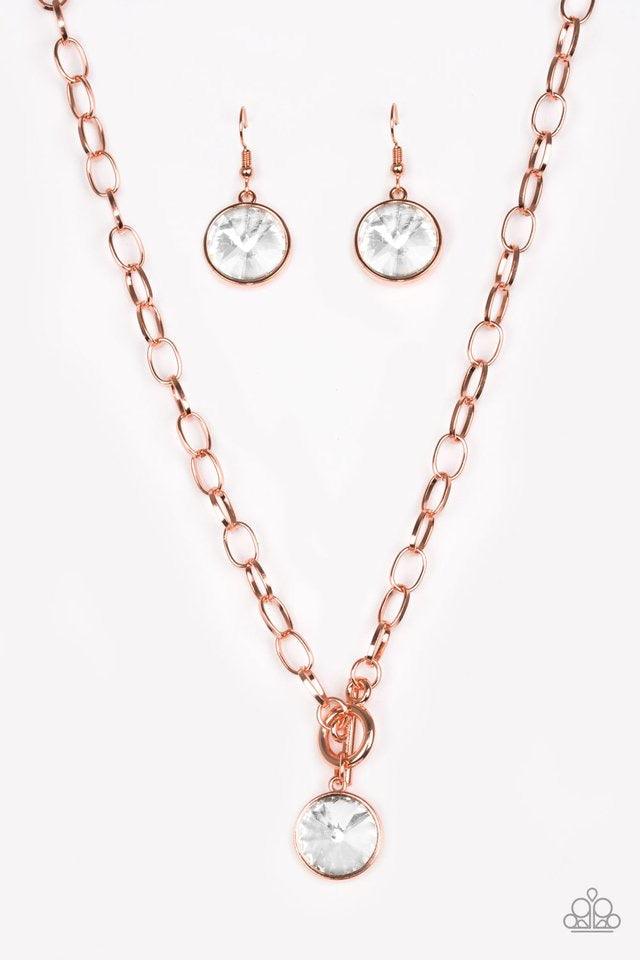 Paparazzi Accessories She Sparkles On - Copper A dramatic white gem swings from the bottom of a shiny copper chain, creating a blinding pendant below the collar. Features a toggle closure. Jewelry