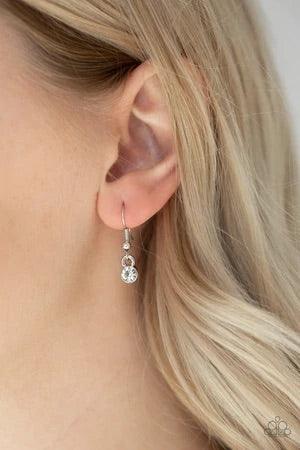 Paparazzi Accessories Notorious Noble - Black A glittery black teardrop gem is pressed into a silver frame radiating with glassy white rhinestones. The glamorous pendant swings from the bottom of a shimmery silver chain for a refined look. Features an adj