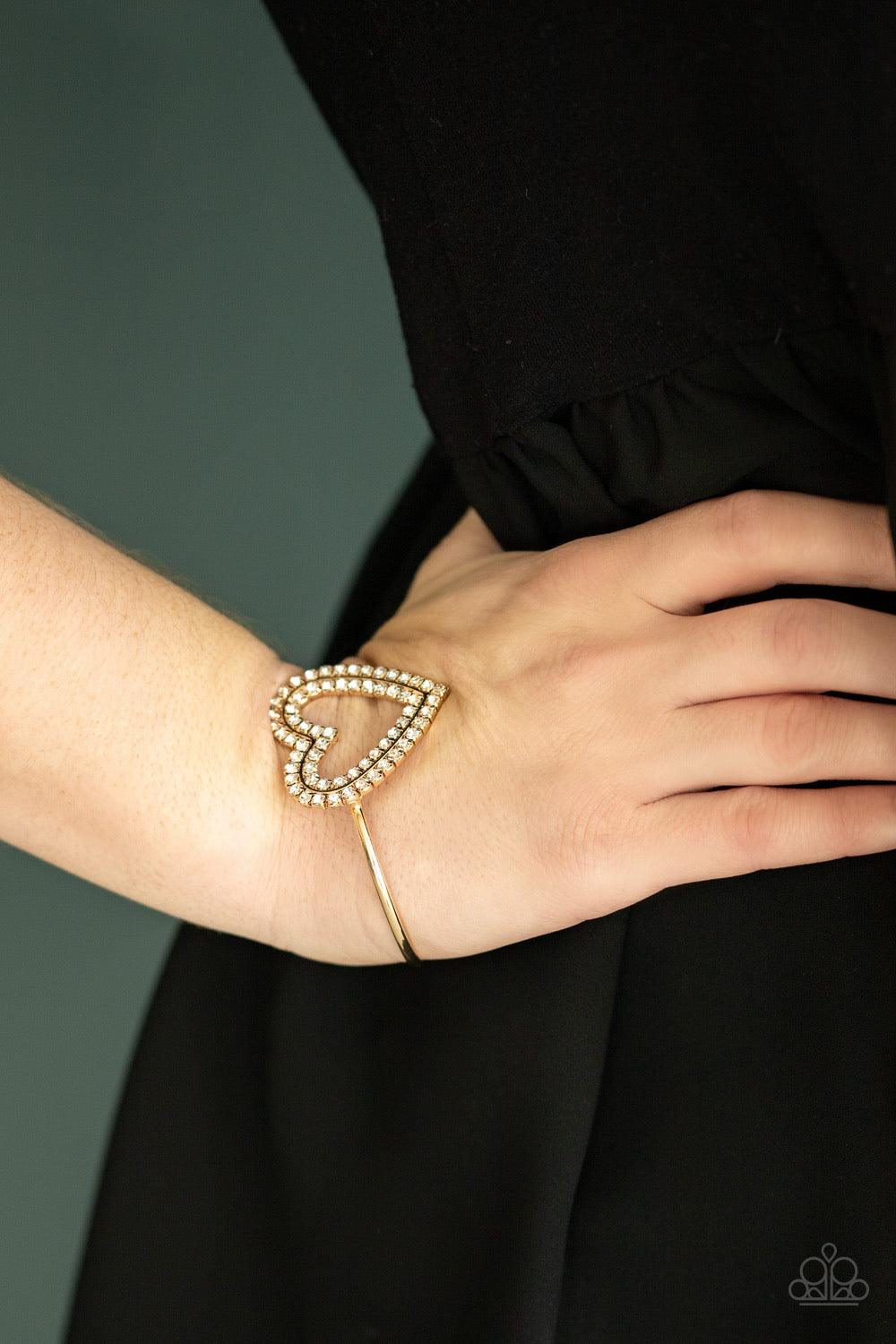 Paparazzi Accessories Heart Opener - Gold Two rows of glittery white rhinestones stack into a sparkling heart atop a dainty gold cuff for a charming look. Jewelry