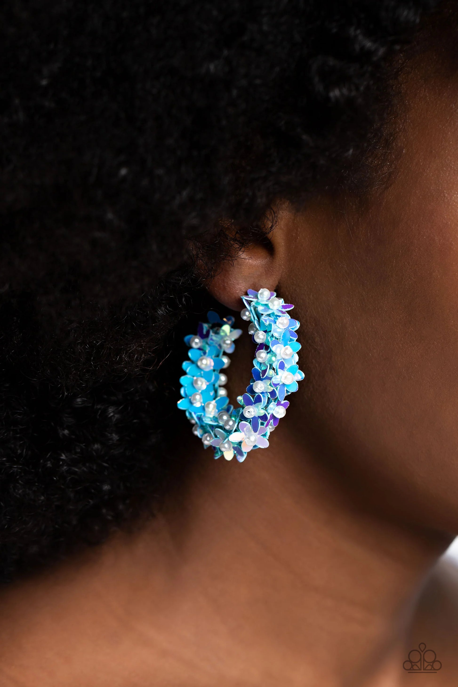 Paparazzi Accessories Fairy Fantasia - Blue A floral explosion, encompassing the entirety of a thick silver hoop, features reflective light blue flowers dotted with dainty pearl centers for a dreamy, whimsicality below the ear. Earring attaches to a stand