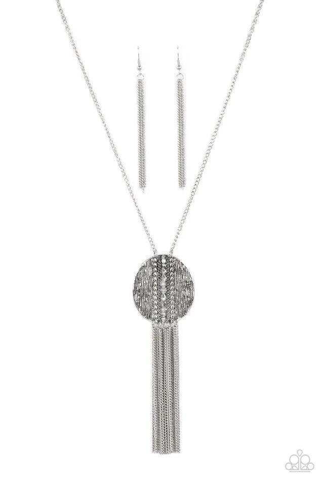 Paparazzi Accessories Radical Refinery- Silver An oversized concave silver disc, ribbed with linear texture, creates a dramatic backdrop for a vertical row of faceted silver beads. A flirty tassel of delicate silver chains sways from the bottom of the pen