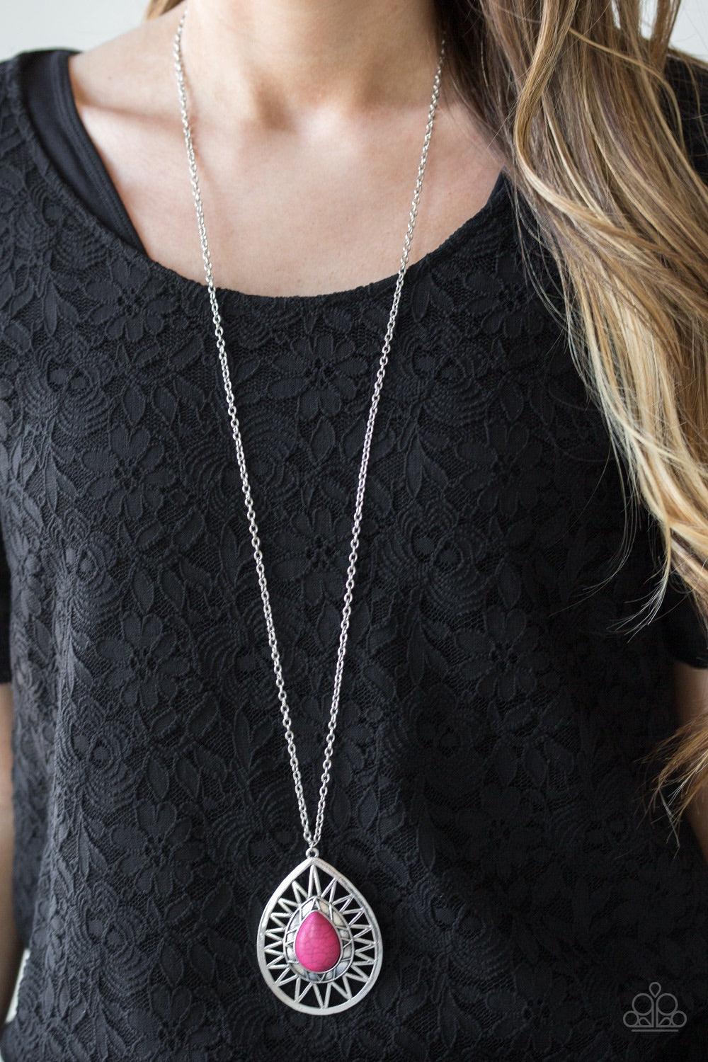 Paparazzi Accessories Summer Sunbeam - Pink A vivacious pink stone is pressed into the center of a large silver teardrop radiating with shimmery sunburst patterns. The tribal inspired pendant swings from the bottom of a lengthened silver chain for a drama