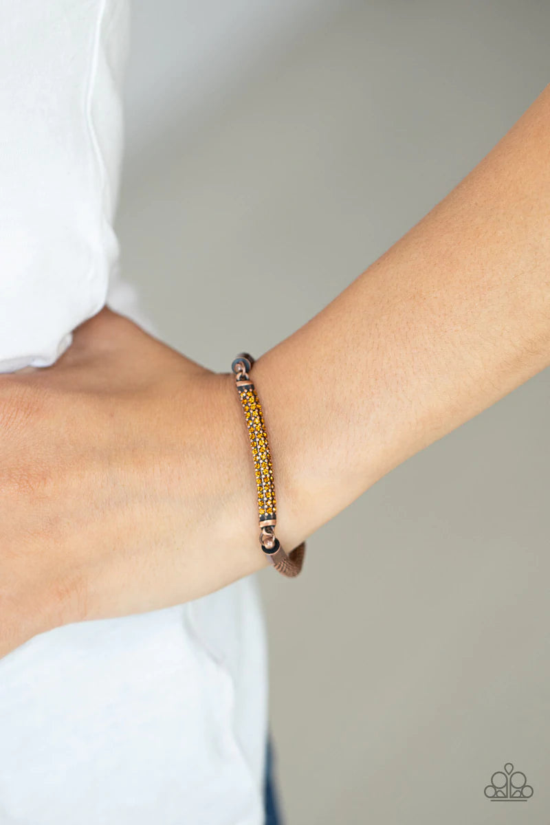 Paparazzi Accessories Fearlessly Unfiltered - Copper Threaded along a stretchy band, a gritty strand of rounded copper mesh chain links with a smoldering copper plate encrusted in rows of dainty topaz rhinestones, creating an edgy shimmer around the wrist