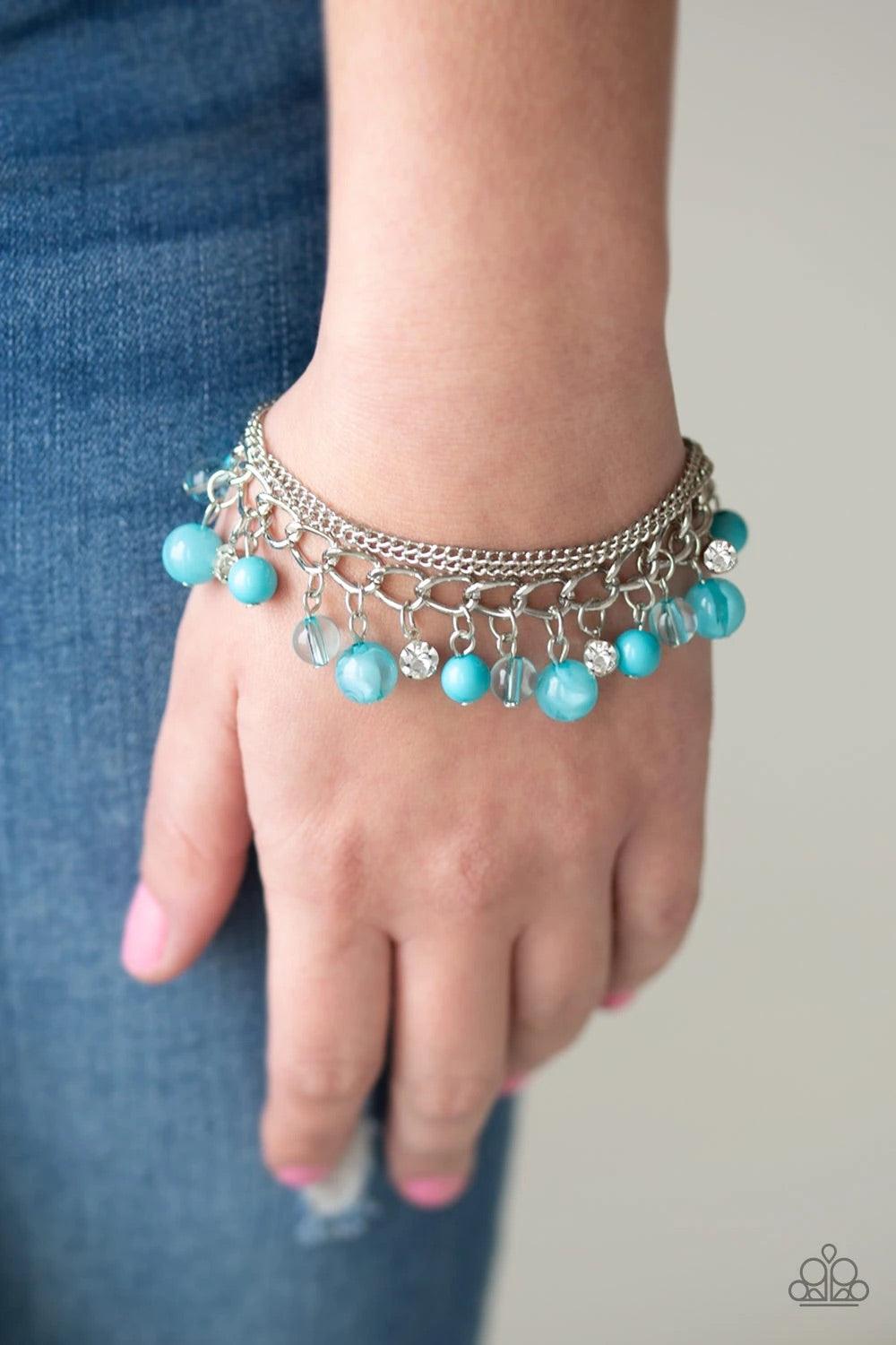 Paparazzi Accessories Let me Sea - Blue Infused with layers of mismatched silver chains, glassy, polished blue, and glittery white rhinestones swing from the wrist in a whimsical fashion. Features an adjustable clasp closure. Sold as one individual bracel