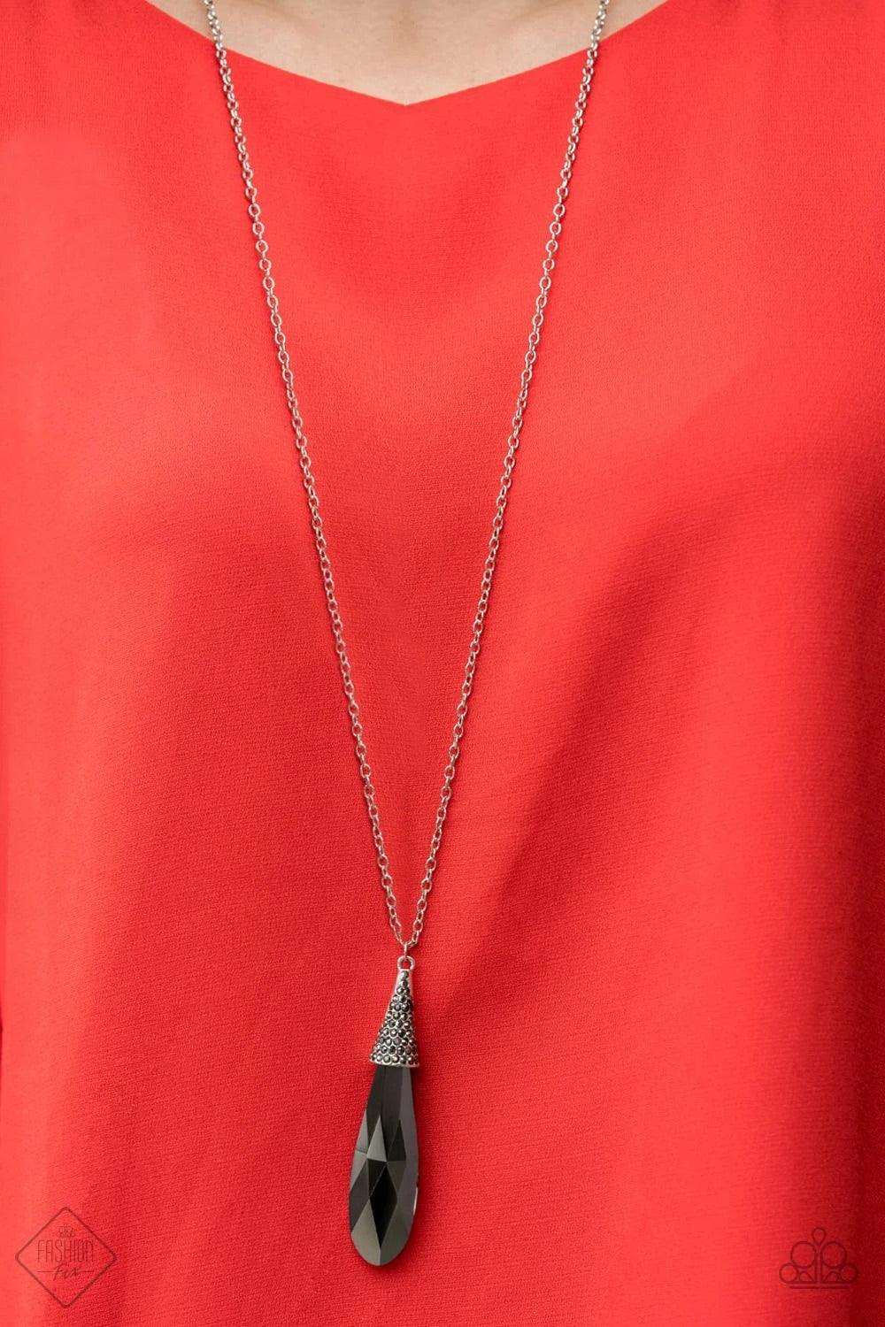 Paparazzi Accessories Jaw-Droppingly Jealous - Black Capped in a silver frame radiating with glittery hematite rhinestones, a smoky metallic teardrop pendant swings from the bottom of a dramatically elongated silver chain, creating a jaw-dropping display.