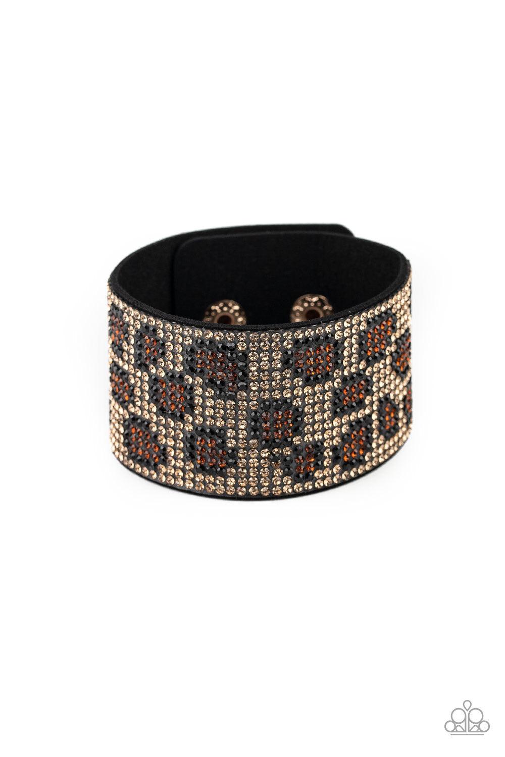 Paparazzi Accessories Cheetah Couture - Brown Row after row of golden brown, black, and topaz rhinestones collect into a dazzling cheetah pattern across the front of a thick black suede band for a wild look. Features an adjustable snap closure. Jewelry