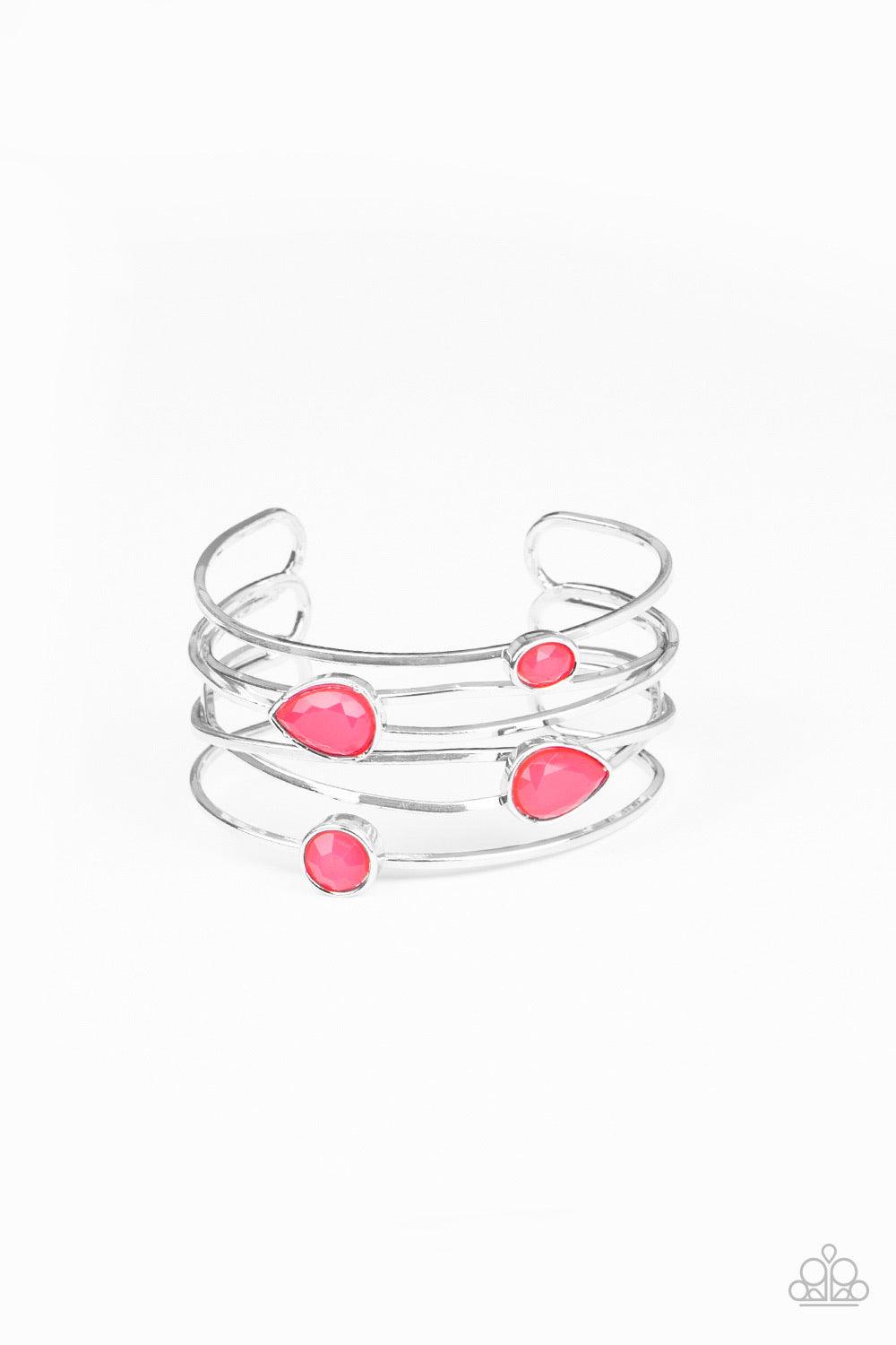 Paparazzi Accessories Fashion Frenzy - Pink Varying in shape, a neon collection of faceted pink beads haphazardly dot the tops of imperfect crisscrossing silver bars, coalescing into a colorfully retro cuff around the wrist. Sold as one individual bracele
