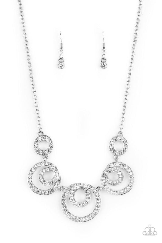 Paparazzi Accessories Total Head-Turner - White Encrusted in glassy white rhinestones, swirling silver frames delicately connect below the collar for a statement-making finish. Features an adjustable clasp closure. Sold as one individual necklace. Include