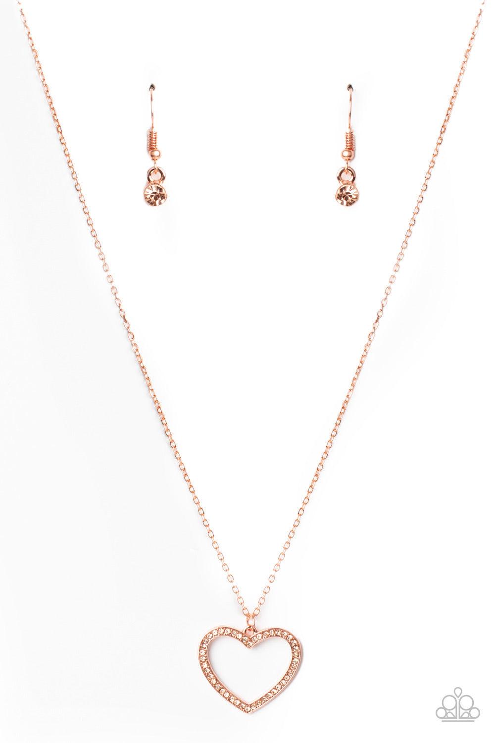 Paparazzi Accessories GLOW By Heart - Copper Encrusted in sparkly rhinestones, an airy shiny copper heart frame swings from a dainty shiny copper chain below the collar for a romantic look. Features an adjustable clasp closure. Sold as one individual neck