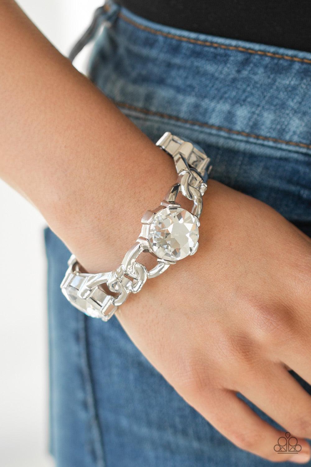 Paparazzi Accessories Light Up The Room - White Featuring glistening silver chain-link fittings, oversized white gem encrusted frames are threaded along a stretchy band around the wrist for a dramatic look. Jewelry