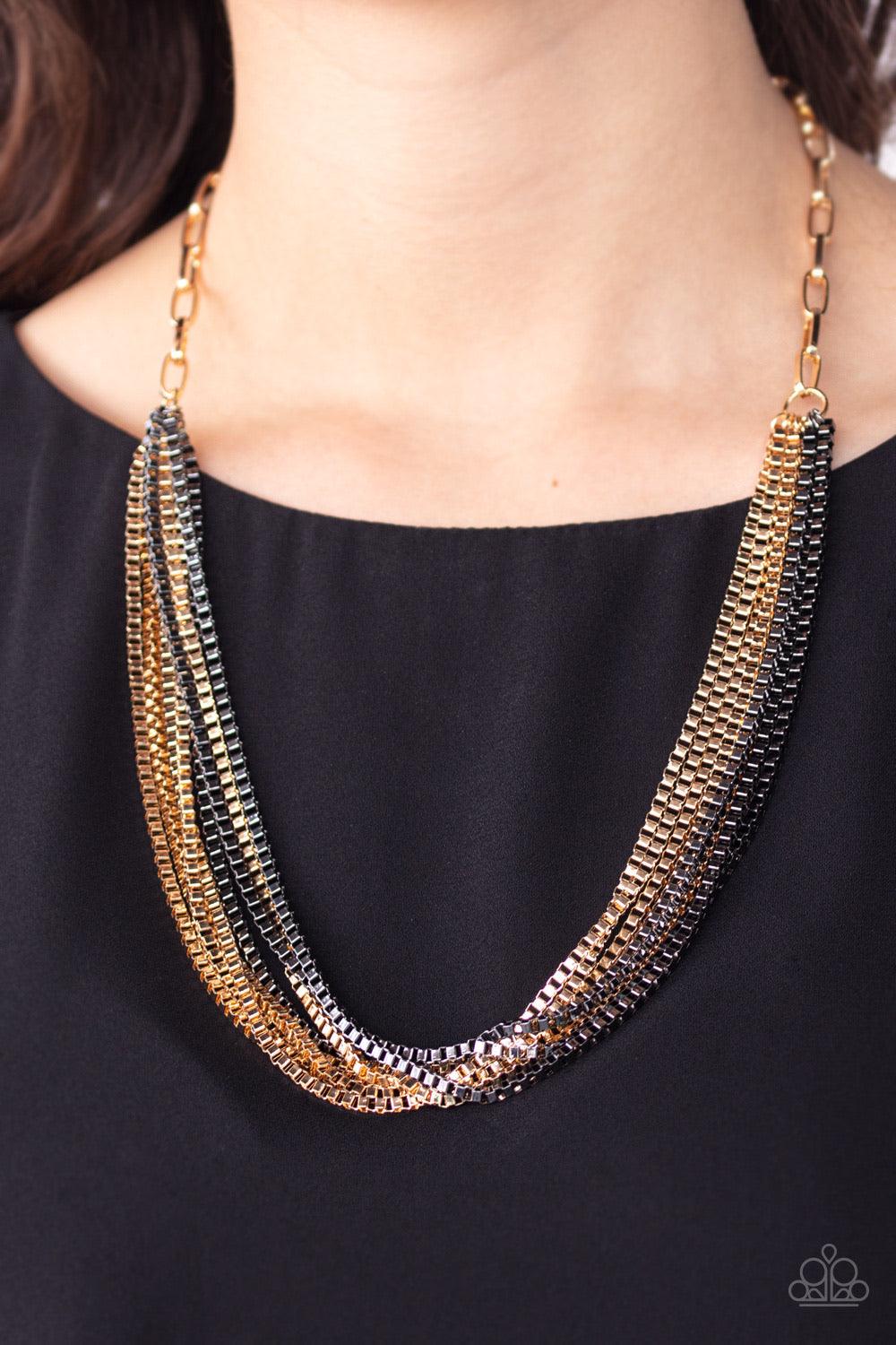 Paparazzi Accessories Beat Box Queen - Gold Attached to a thick gold chain, a collision of gunmetal and gold box chains layer below the collar for an edgy mix. Features an adjustable clasp closure. Sold as one individual necklace. Includes one pair of mat