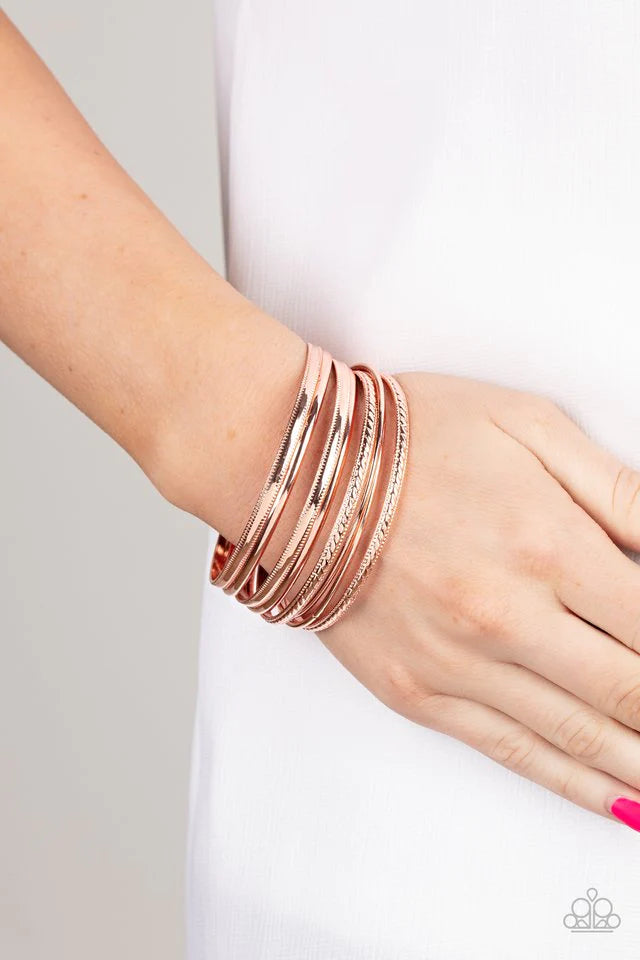 Paparazzi Accessories Stackable Shimmer - Copper A collection of classic shiny copper bangles, varying in smooth and textured finishes creates a sassy look as they layer around the wrist. Bracelets