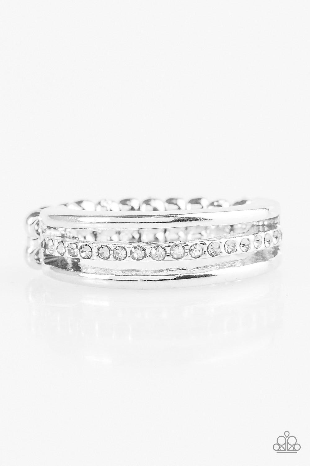 Paparazzi Accessories Center Court - White Dainty silver bands layer across the finger. The centermost band is encrusted in white rhinestones for a glamorous finish. Features a dainty stretchy band for a flexible fit. Jewelry