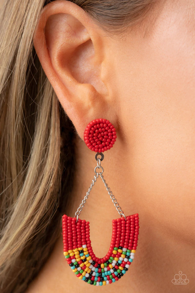Paparazzi Accessories Make It Rainbow - Red Adorned in sections of red and multicolored seed beaded accents, a colorful rainbow swings from the bottom of shimmery silver chains that attach to a red seed beaded disc for a bohemian inspired fashion. Earring