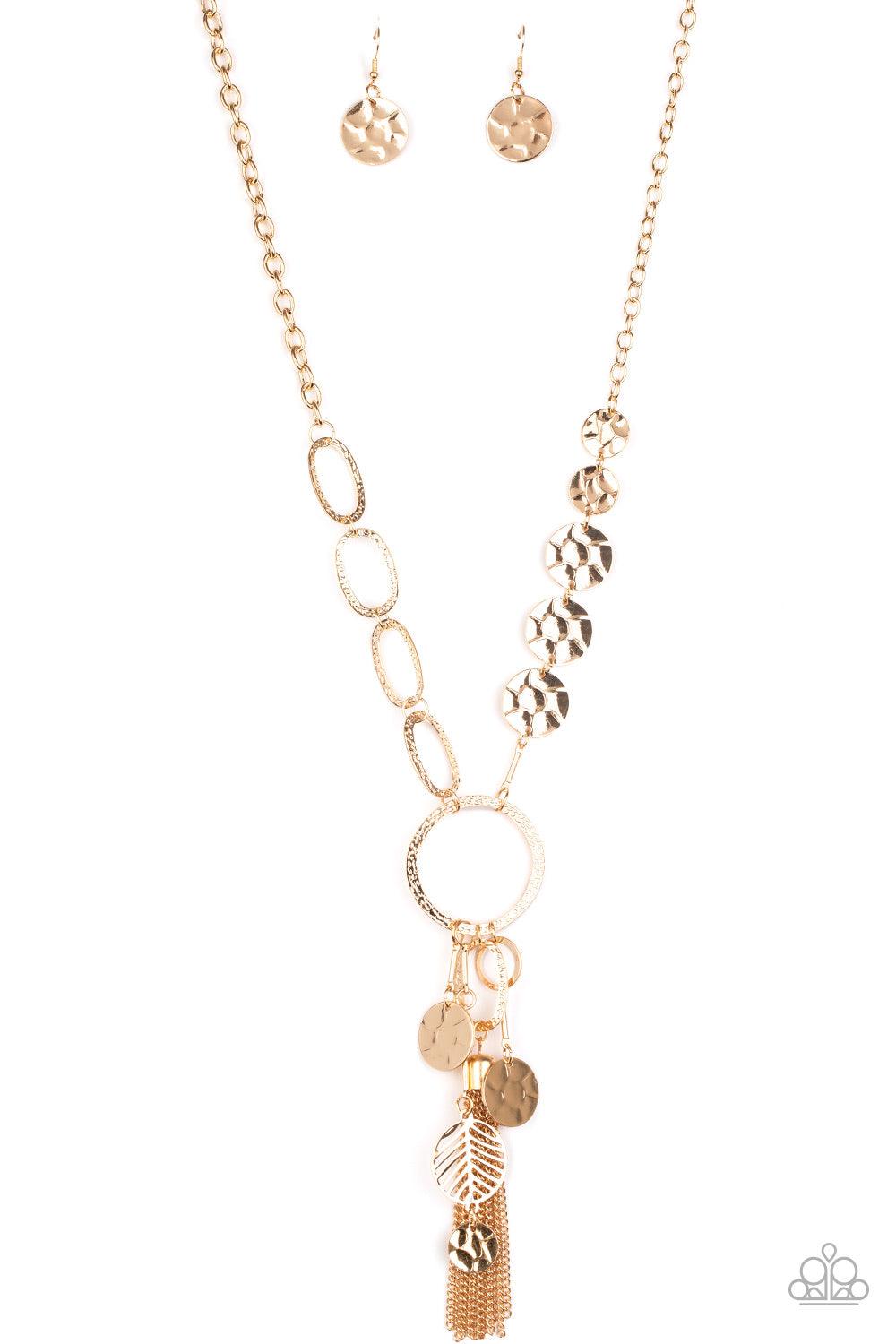 Paparazzi Accessories Trinket Trent ~Gold One row of hammered gold discs and one row of hammered oval links give way to an oversized hammered gold hoop. A collection of gold discs, hammered links, abstract gold pieces, and a shimmery gold chain tassel dan