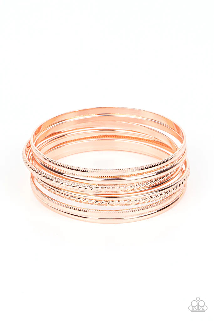 Paparazzi Accessories Stackable Shimmer - Copper A collection of classic shiny copper bangles, varying in smooth and textured finishes creates a sassy look as they layer around the wrist. Bracelets