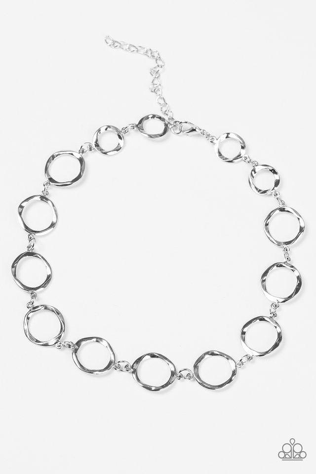 Paparazzi Accessories Cave Tour - Silver *Choker Delicately hammered in shimmery textures, asymmetrical silver hoops link around the neck in an artisan inspired fashion. Features an adjustable clasp closure. Jewelry