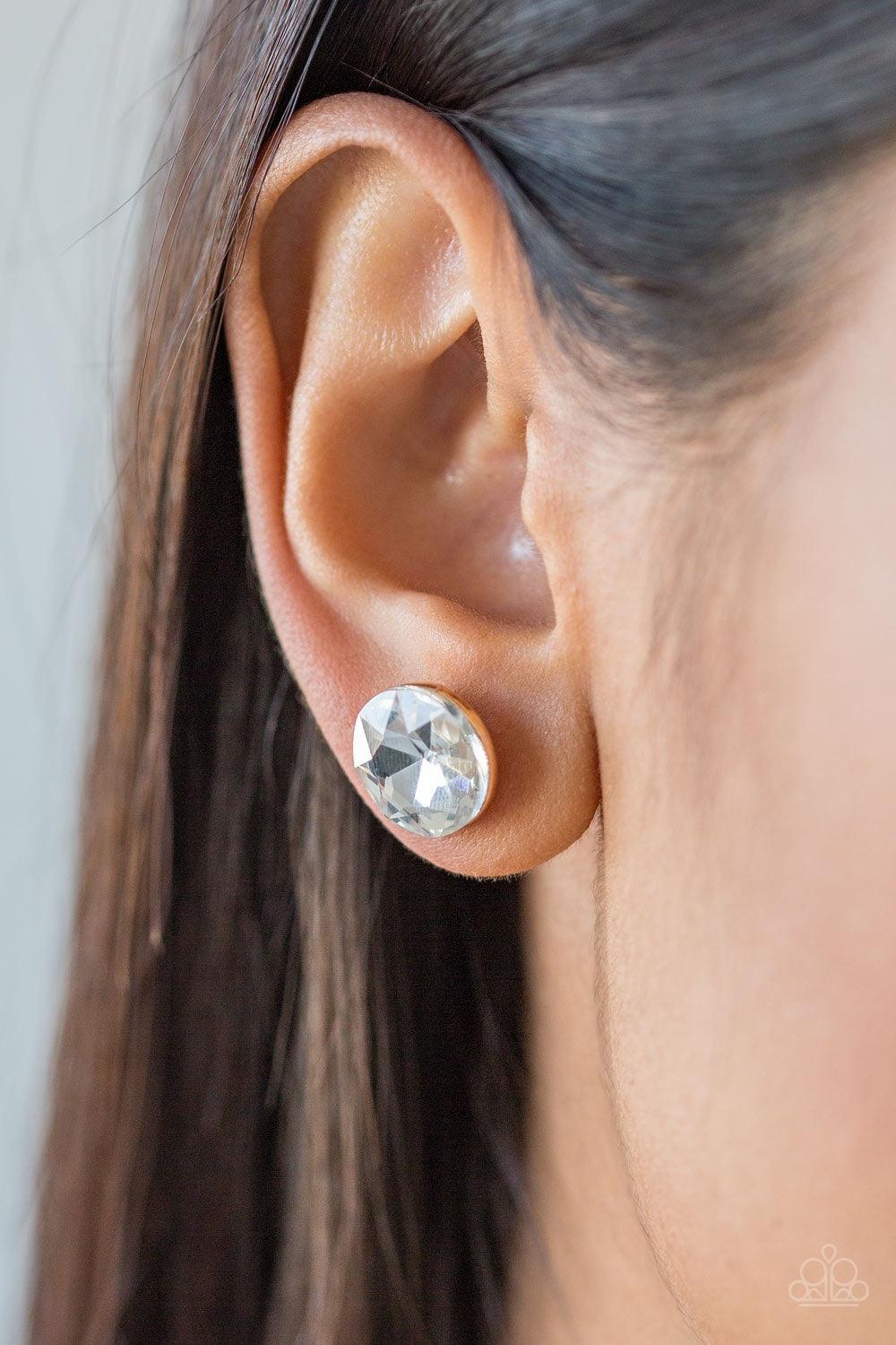 Paparazzi Accessories GLOWING, GLOWING, Gone - Gold A sparkling white rhinestone is nestled inside a round gold frame for a timeless look. Earring attaches to a standard post fitting. Jewelry
