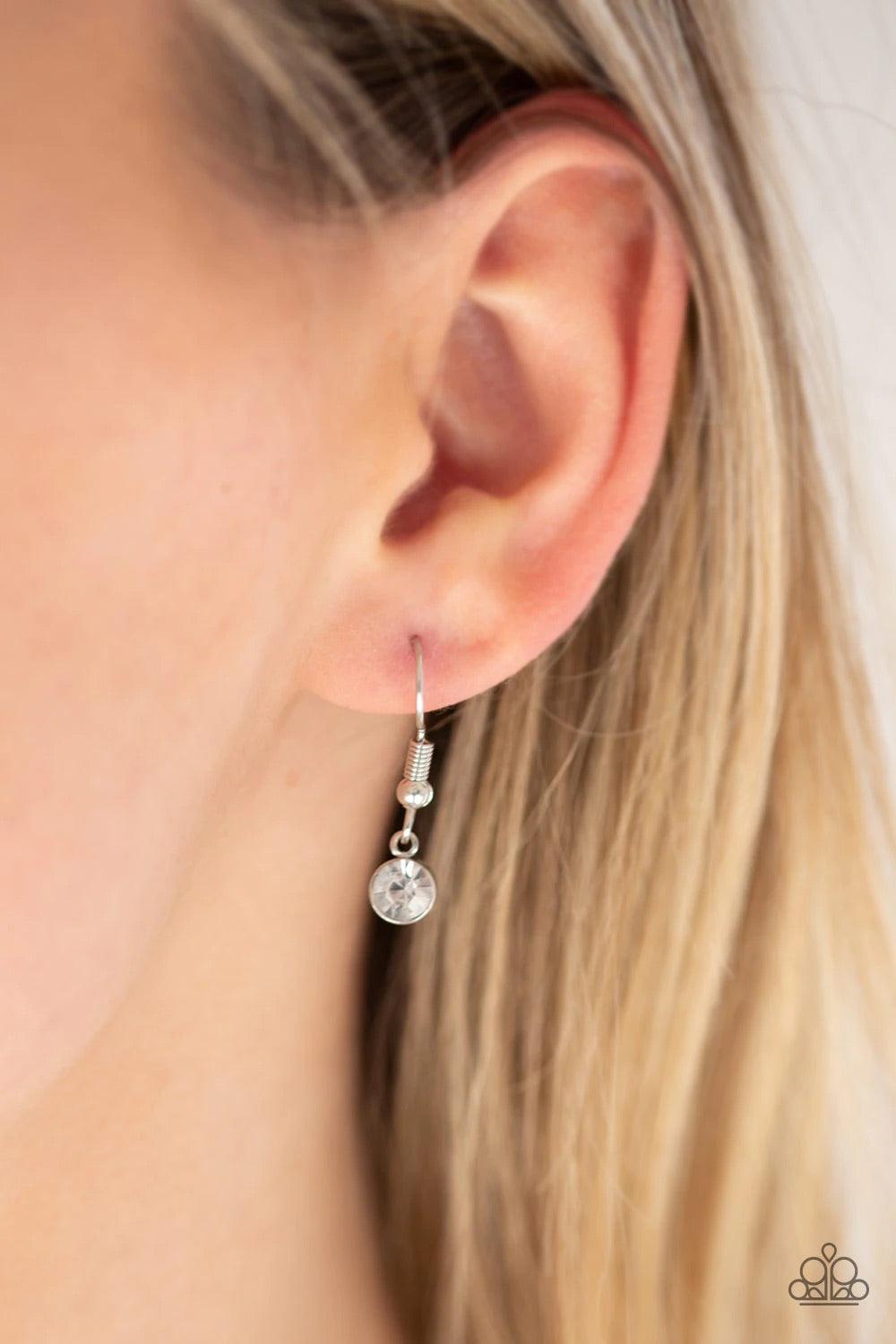 Paparazzi Accessories Come of AGELESS - Green Featuring an iridescent finish, a dramatic green teardrop gem is pressed into a shimmery silver frame radiating with glassy white rhinestones. The glamorous pendant swings from the bottom of a dainty silver ch