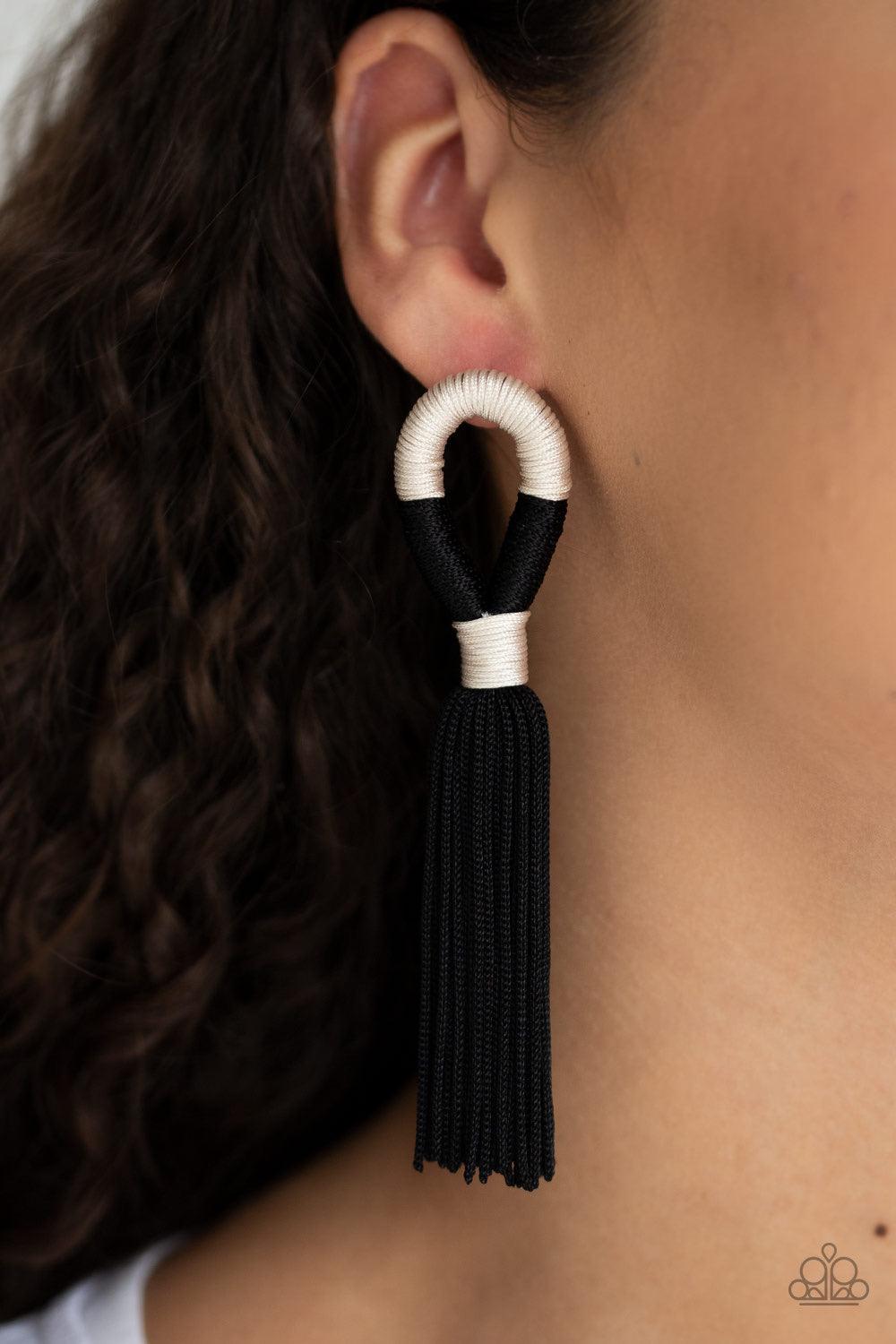 Paparazzi Accessories Moroccan Mambo - Black Shiny off-white and black cording knots around a round fitting as a plume of soft black cording free-falls from the bottom, creating a trendy tassel. Earring attaches to a standard post fitting. Sold as one pai