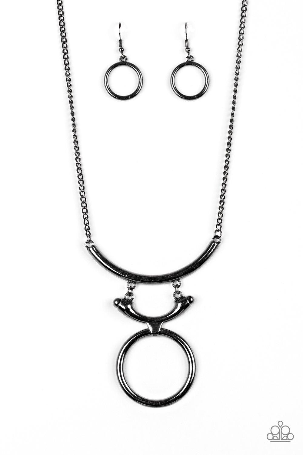 Paparazzi Accessories Walk Like An Egyptian - Black Two glistening gunmetal crescents attach to a large gunmetal hoop, creating a tribal inspired pendant below the collar. Features an adjustable clasp closure. Jewelry