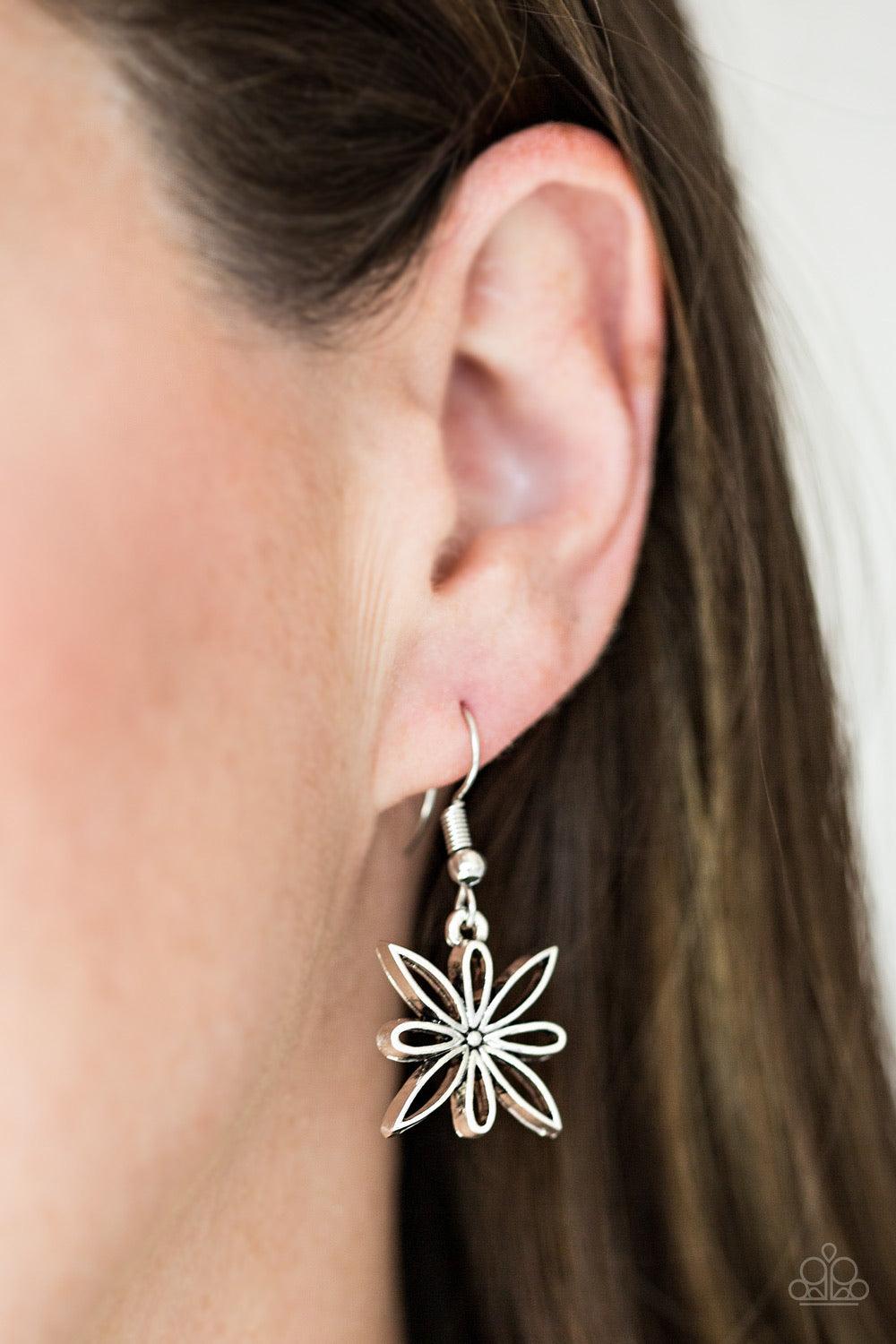 Paparazzi Accessories Decked Out In Daisies - Silver Airy silver floral charms link below the collar for a seasonal look. Dainty hematite rhinestones are encrusted along the petals of alternating floral frames for a glamourous finish. Features an adjustab