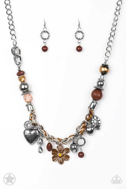 Paparazzi Accessories Charmed, I Am Sure - Brown Brown and ivory cording is braided through a chunky silver chain. A unique variety of charms decorate the piece including a delicate flower and a heart inscribed with the phrase "With All My Heart" on one s